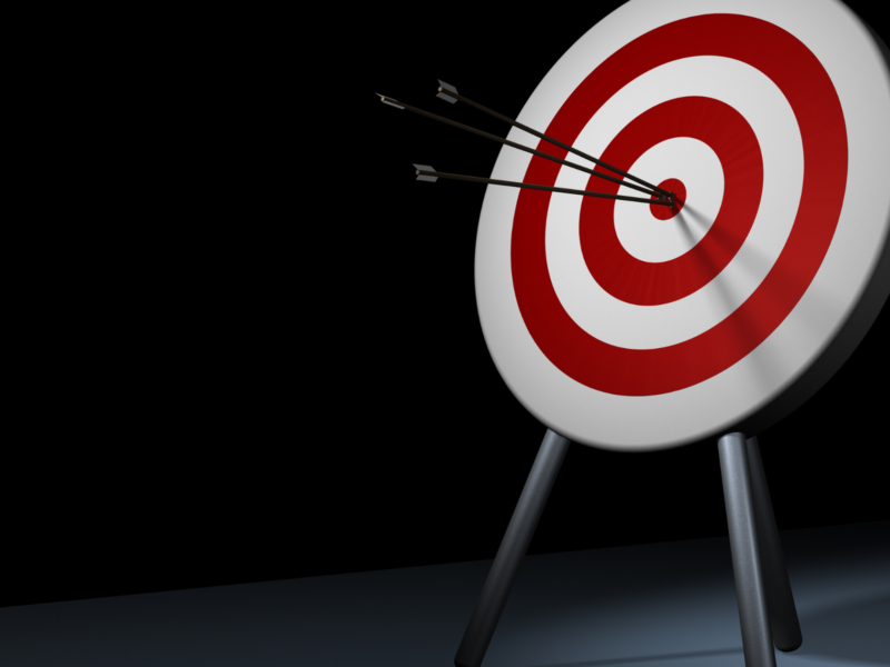 Three arrows accurately striking the bullseye on a target board.