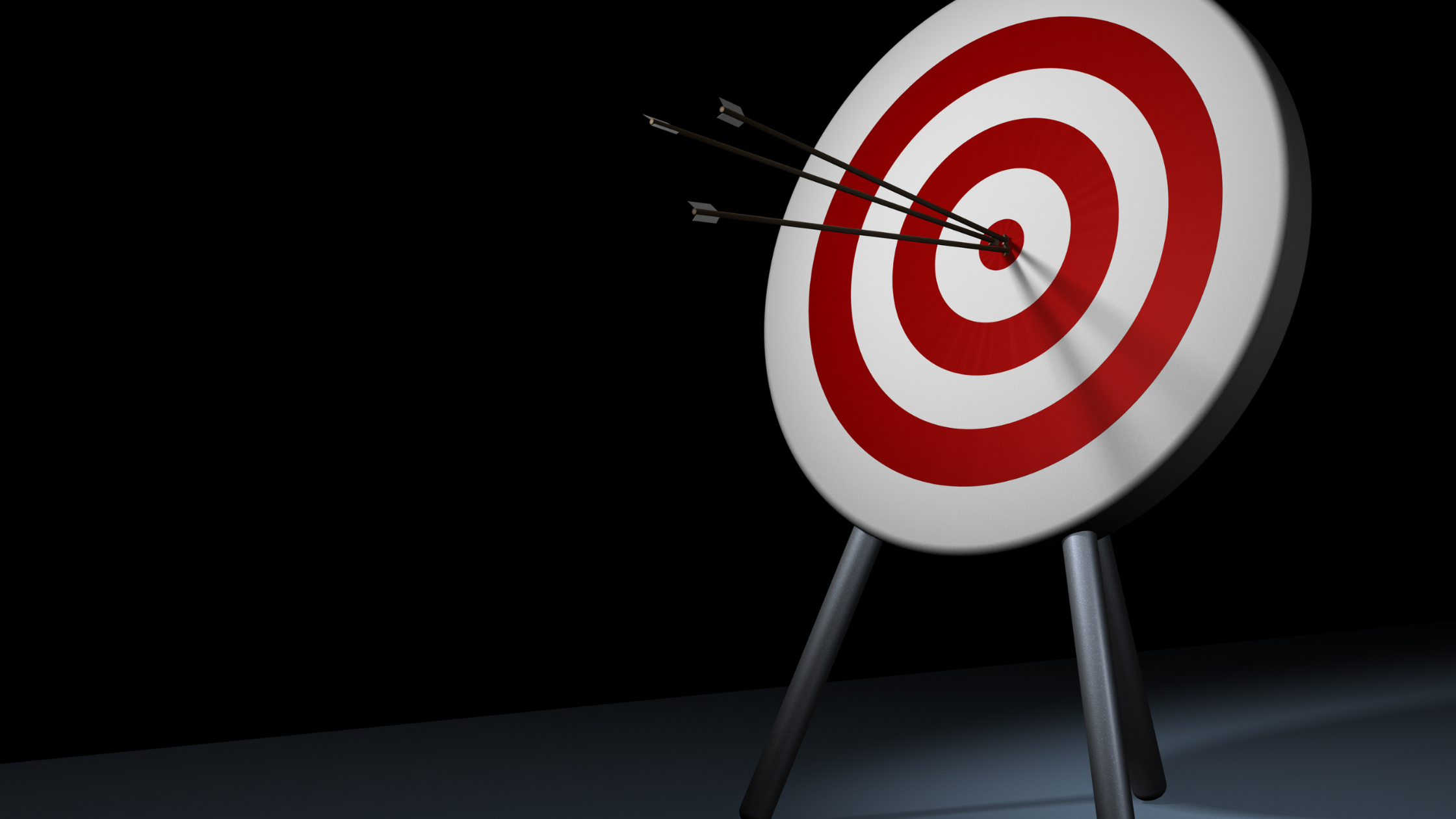 Three arrows accurately striking the bullseye on a target board.
